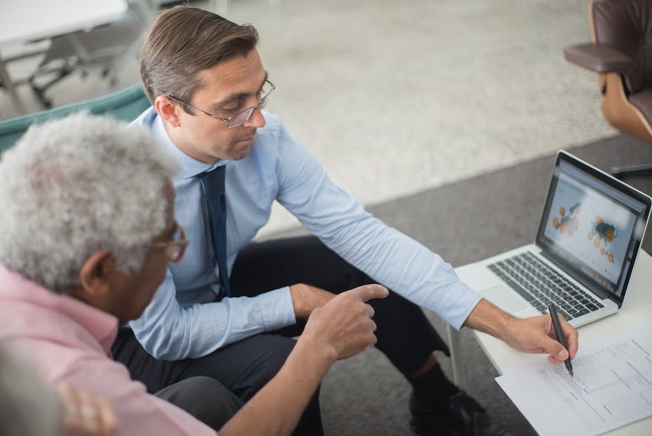 Senior man reviewing indemnity insurance paperwork at kitchen table