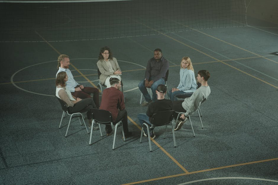 Group therapy room at intensive outpatient program with circle of chairs and counselor