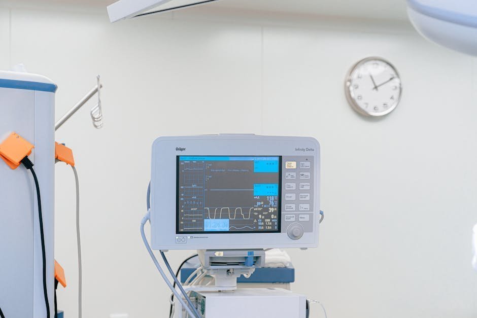 ICU monitor displaying vital signs alongside medication infusion pumps in a hospital intensive care setting