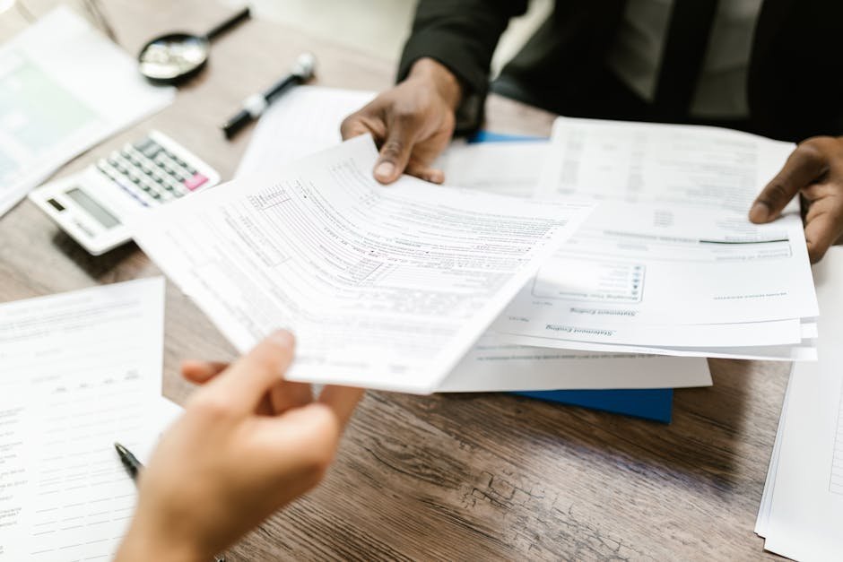 Hospital financial counselor reviewing charity care application with patient at billing desk