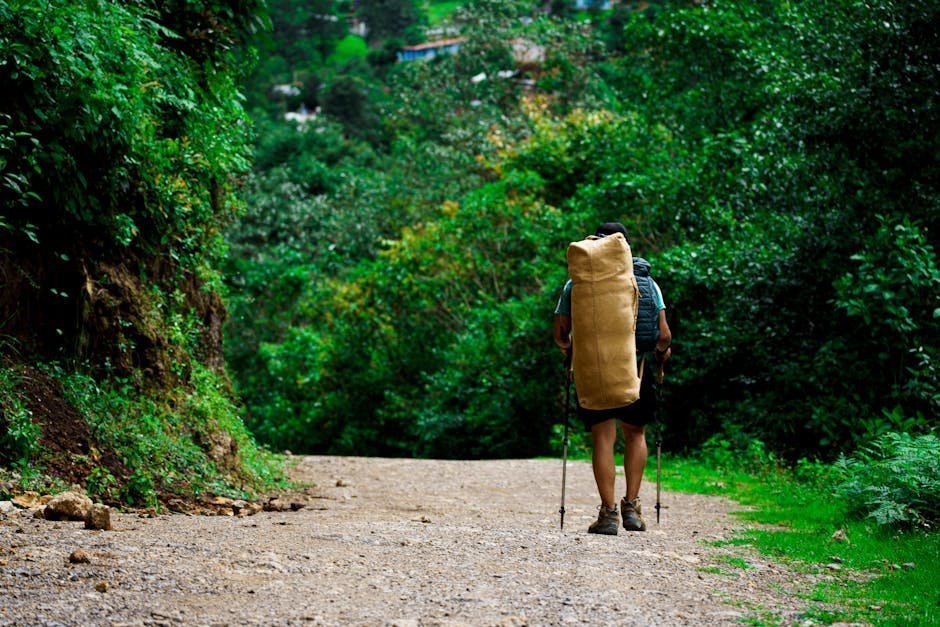 Solo traveler walking a stone path through northern Portugal countryside with backpack and journal