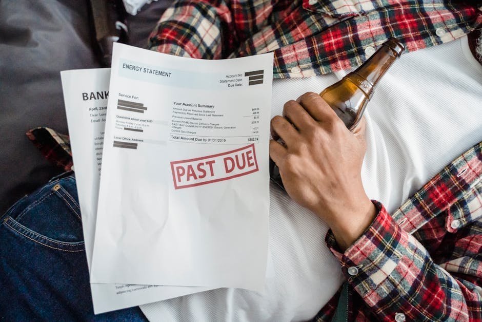 Person reviewing medical bills and bankruptcy paperwork at desk with worried expression