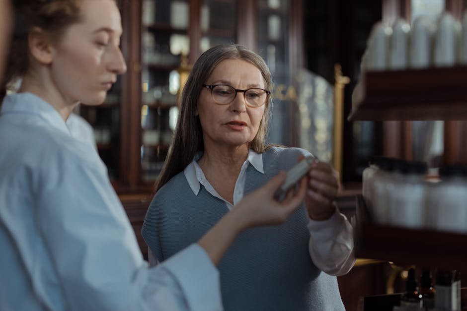 Pharmacist counseling patient holding orange prescription bottle of benzodiazepine tablets