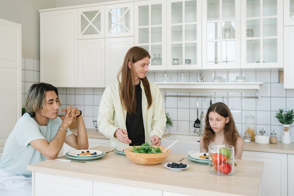Family at a kitchen table reviewing health sharing ministry paperwork