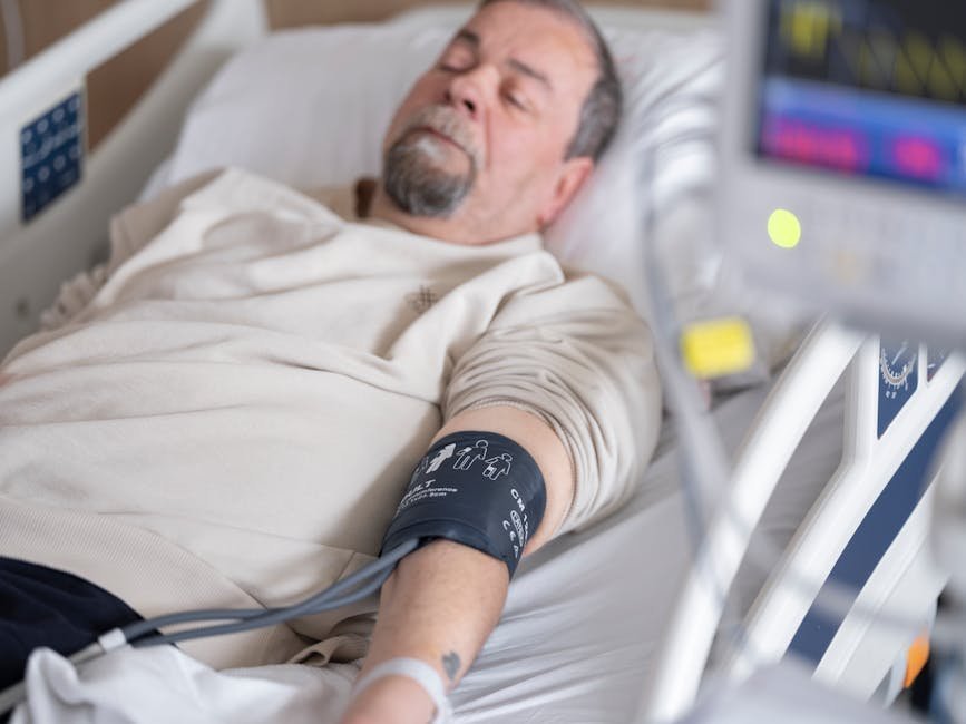 Hospital bed with elderly patient showing catatonic posturing assessed by psychiatry resident