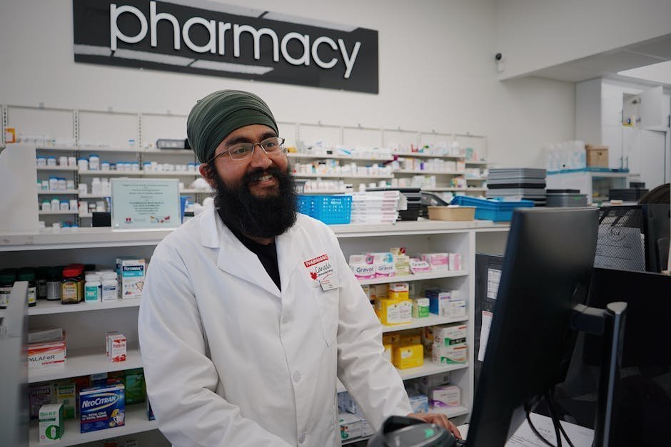 Pharmacist demonstrating over-the-counter naloxone nasal spray to community member