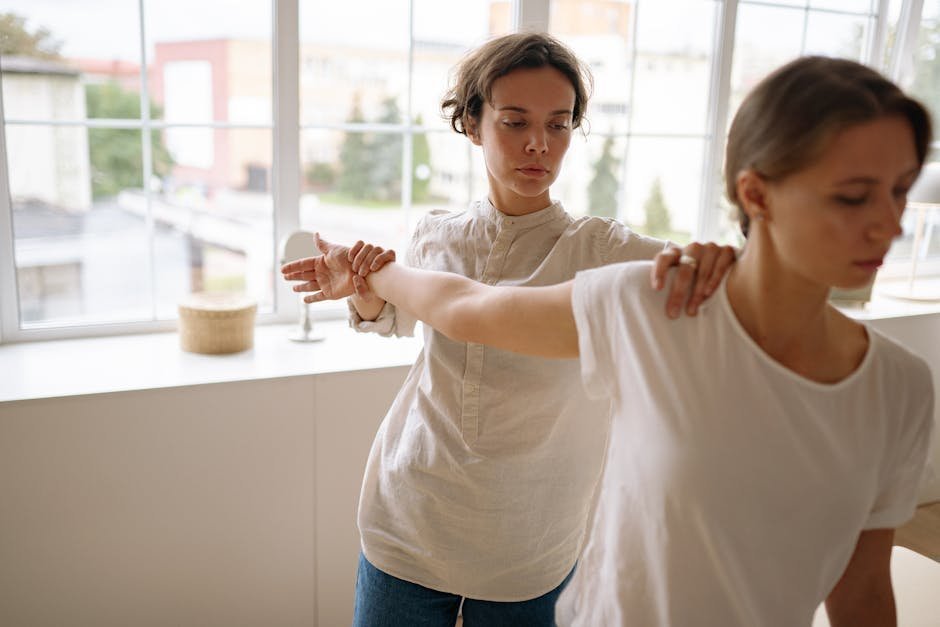 Stroke survivor sitting by window in physical therapy clinic, illustrating recovery and depression context