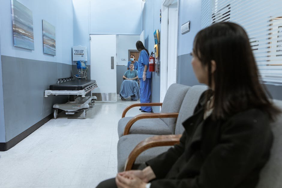Pediatric emergency department waiting area with parent comforting a teenager