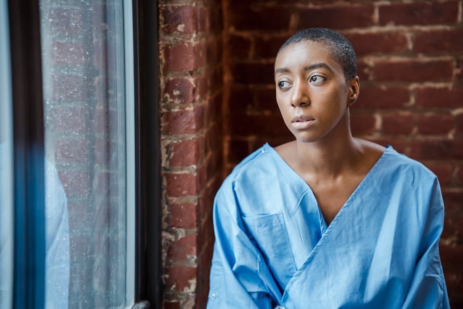 Older patient sitting alone by hospital window during postoperative depression recovery