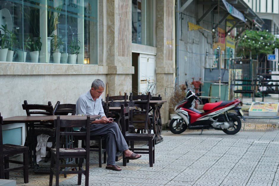 Older man sitting alone at kitchen table early morning