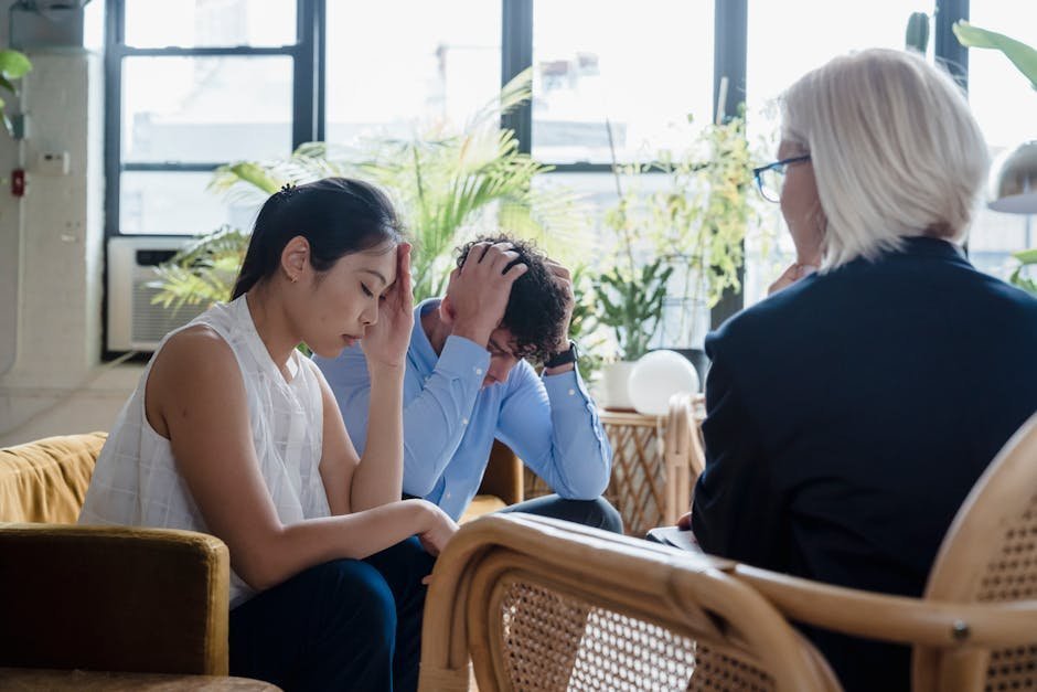 Asian American man in therapy office speaking with Asian therapist
