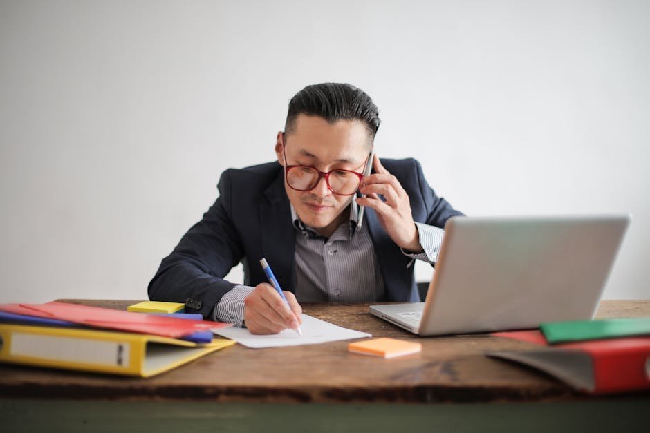 Person with phone and spreadsheet documenting calls to therapists