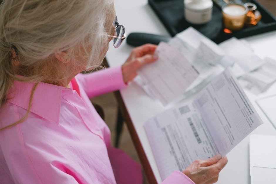 Senior woman reviewing Medicare Advantage paperwork at her kitchen table