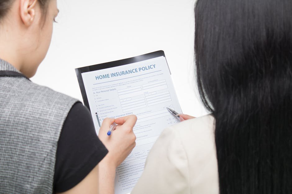 Person reviewing health insurance plan documents at a kitchen table